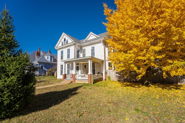 view of front facade with a porch and a front lawn