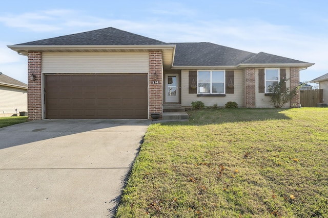 single story home featuring a garage and a front yard