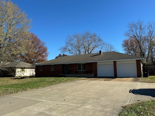 single story home with a garage and a front lawn