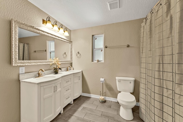 bathroom with vanity, toilet, a textured ceiling, curtained shower, and wood-type flooring