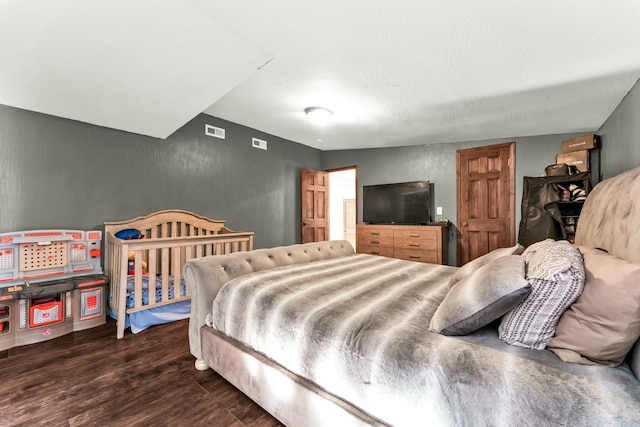 bedroom with dark wood-type flooring