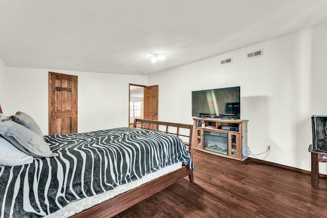 bedroom featuring hardwood / wood-style flooring and lofted ceiling