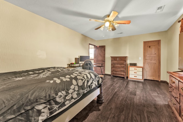 bedroom featuring ceiling fan and dark wood-type flooring