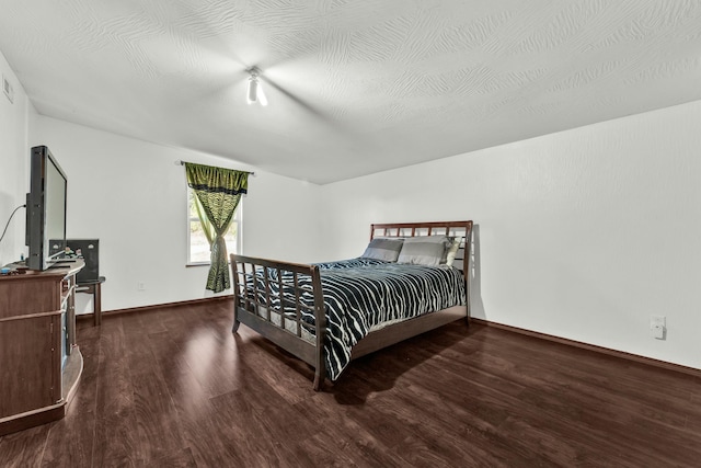 bedroom with hardwood / wood-style flooring and a textured ceiling