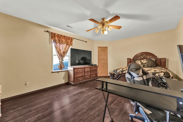 bedroom featuring ceiling fan and dark hardwood / wood-style floors