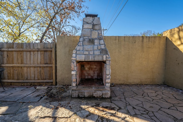 view of patio / terrace with an outdoor stone fireplace