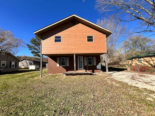 back of house featuring a yard