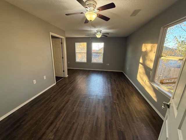 spare room featuring a textured ceiling, ceiling fan, and dark hardwood / wood-style floors