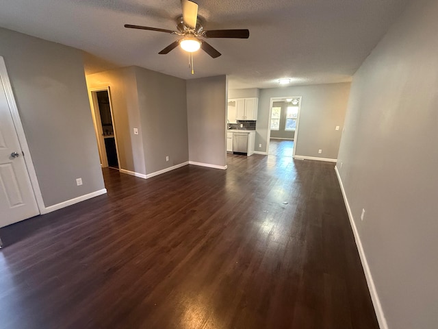 unfurnished living room with a textured ceiling, dark hardwood / wood-style flooring, and ceiling fan