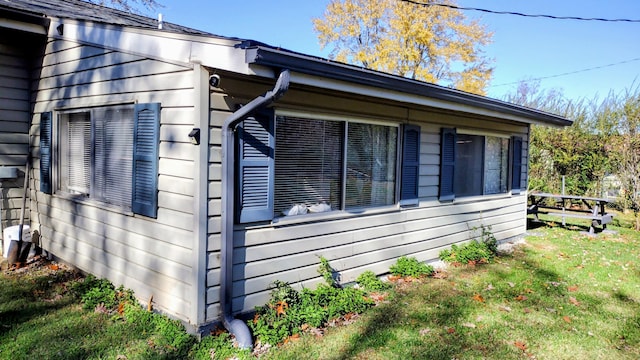 view of home's exterior with a yard