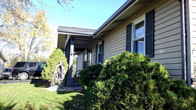 view of property exterior featuring a lawn