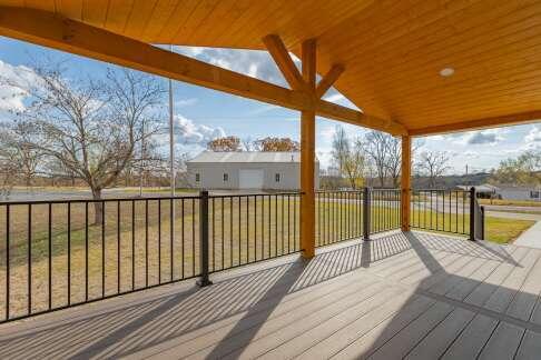 wooden terrace featuring a yard