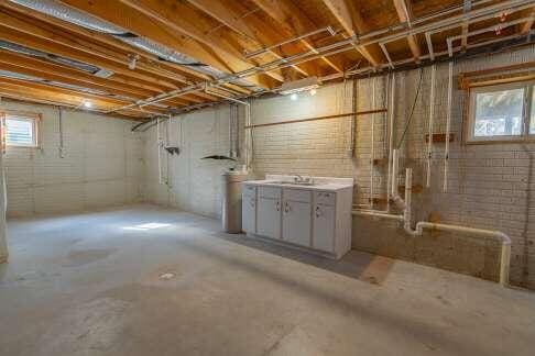 basement featuring sink and a healthy amount of sunlight