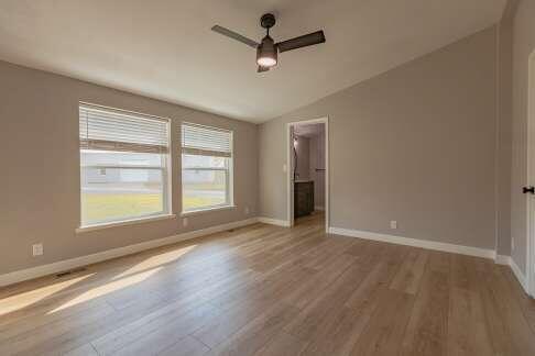 interior space with ceiling fan, light hardwood / wood-style floors, and vaulted ceiling