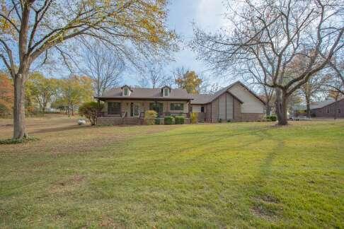 view of front of home with a porch and a front yard