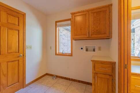 clothes washing area featuring light tile patterned floors, hookup for a washing machine, baseboards, cabinet space, and electric dryer hookup