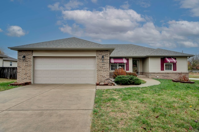 view of front of property with a front yard and a garage