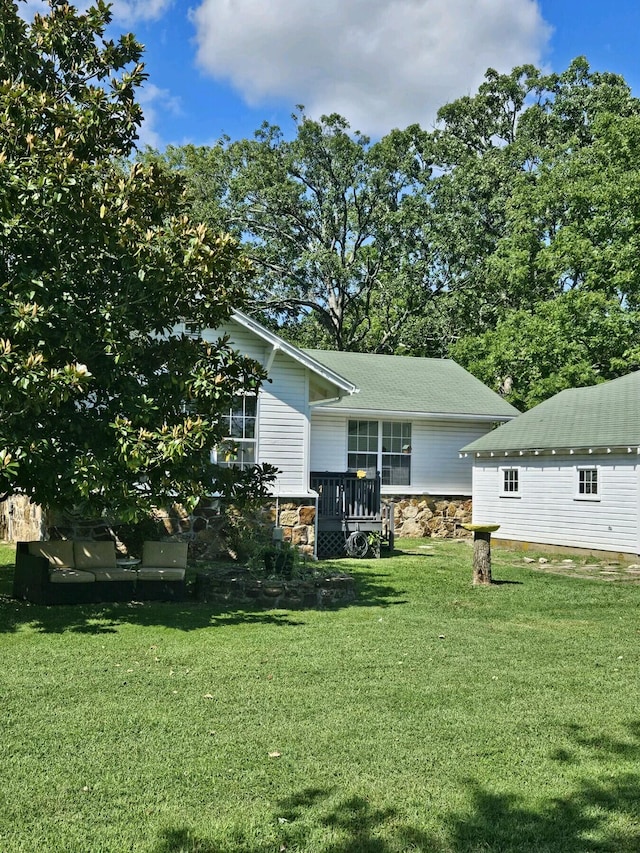 exterior space with a deck and a front yard