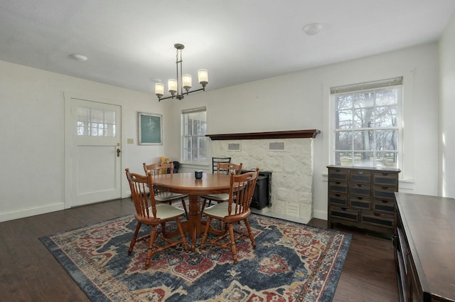 dining area featuring dark wood-type flooring and a chandelier