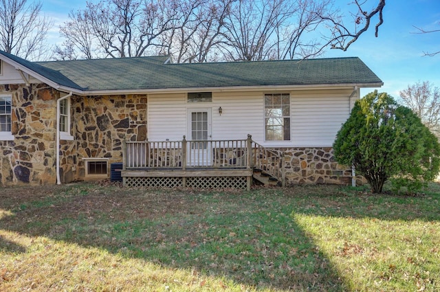 exterior space with a deck and a lawn