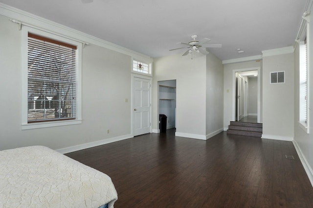 bedroom with crown molding, ceiling fan, and dark wood-type flooring