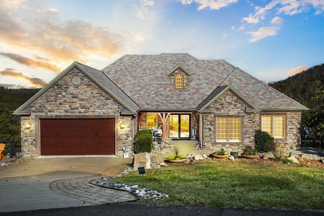 view of front of property with a yard and a garage