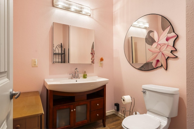 bathroom with toilet and vanity