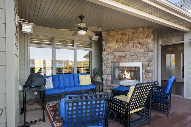 view of patio / terrace with an outdoor stone fireplace and ceiling fan