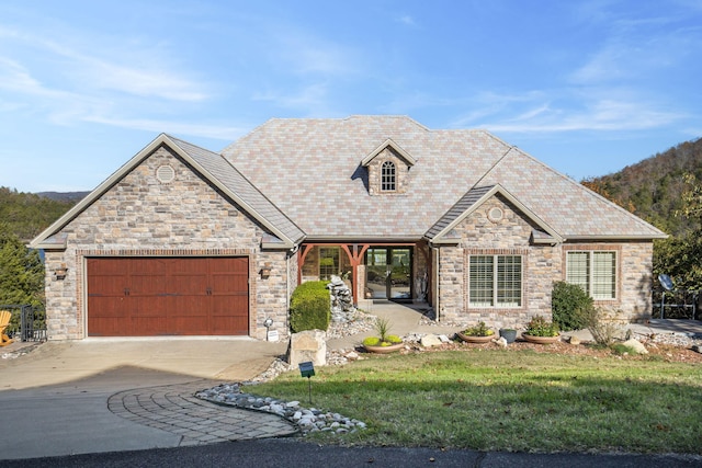 view of front of property featuring a garage and a front yard