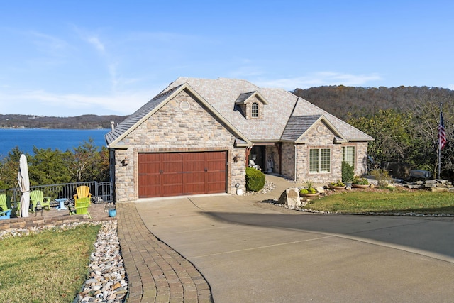 view of front of home featuring a garage and a water view