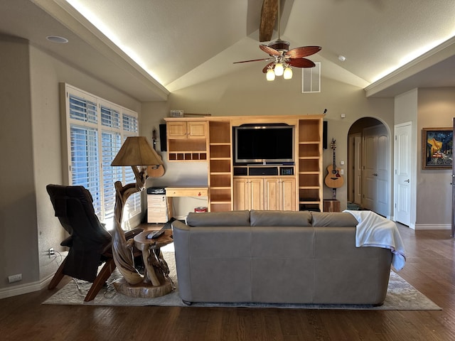 living room with ceiling fan, dark wood-type flooring, and lofted ceiling