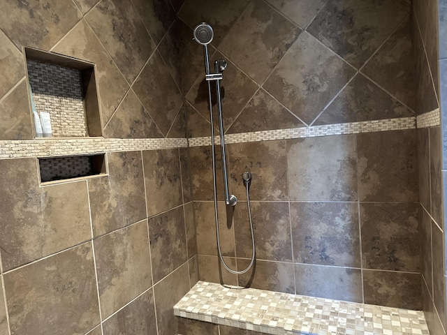 interior details with a tile shower