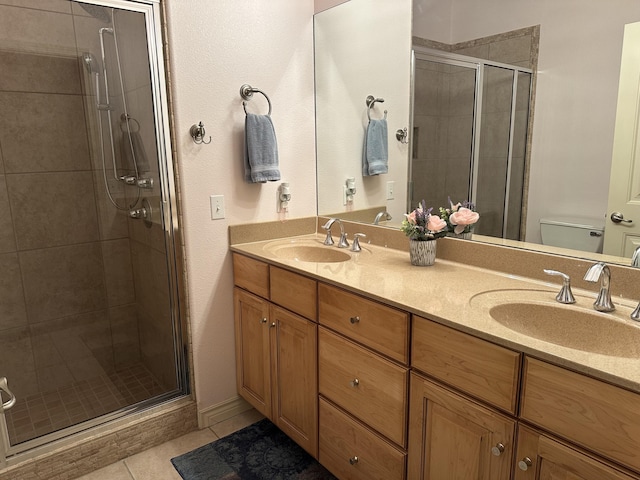 bathroom featuring an enclosed shower, vanity, toilet, and tile patterned flooring