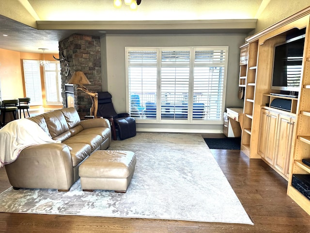 living room with dark wood-type flooring, a chandelier, and a textured ceiling