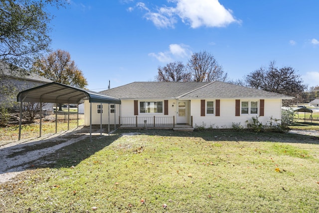 view of front of home with a carport and a front lawn