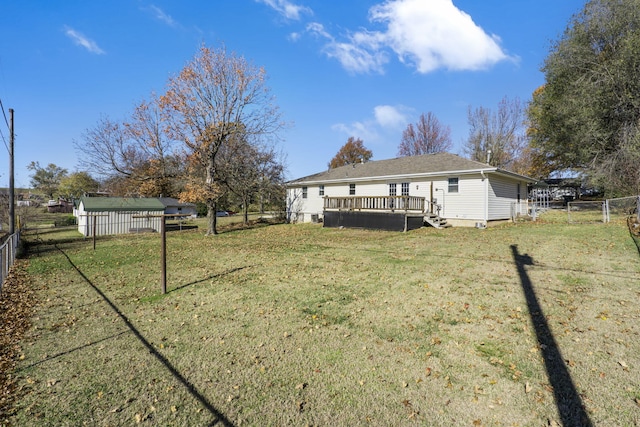 exterior space with a wooden deck and a lawn