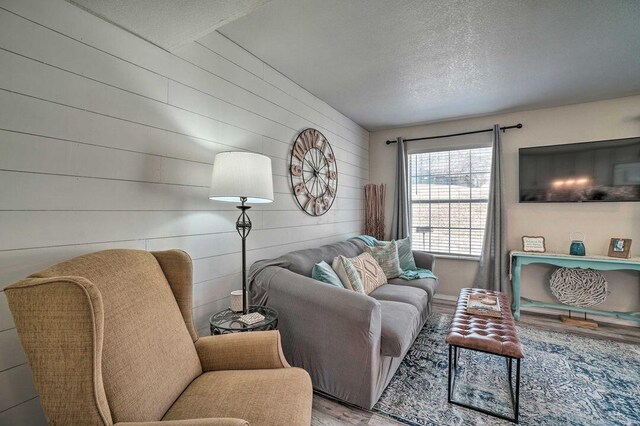 570 Abby Ln Unit 3, Branson, MO 65616 - living room with a textured ceiling, wooden walls, and wood finished floors