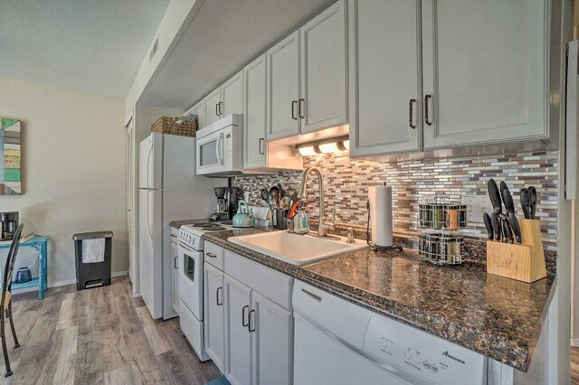 570 Abby Ln Unit 3, Branson, MO 65616 - kitchen with white appliances, a sink, tasteful backsplash, light wood-style floors, and white cabinets