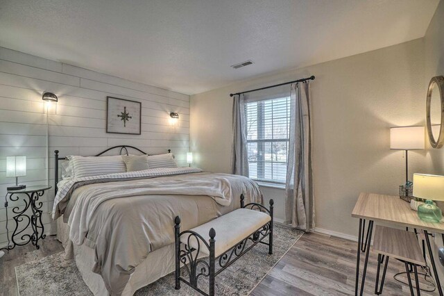 570 Abby Ln Unit 3, Branson, MO 65616 - bedroom featuring wood finished floors, wooden walls, and baseboards
