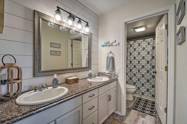 570 Abby Ln Unit 3, Branson, MO 65616 - full bathroom featuring double vanity, toilet, wood finished floors, and a shower with shower curtain