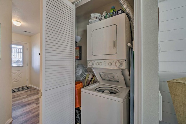 570 Abby Ln Unit 3, Branson, MO 65616 - laundry area with stacked washer and clothes dryer, wood finished floors, and baseboards