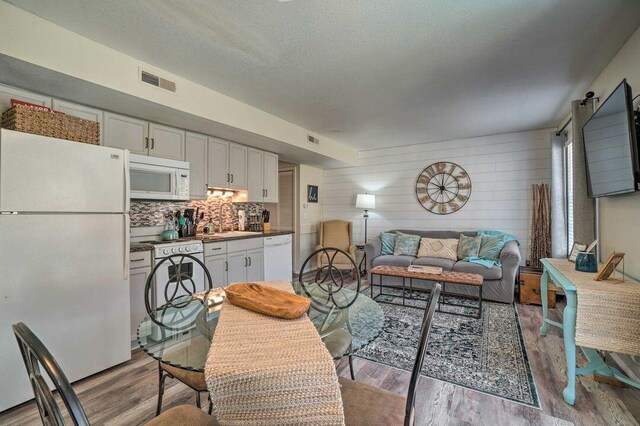 570 Abby Ln Unit 3, Branson, MO 65616 - living room with light wood-style floors, wood walls, and a textured ceiling