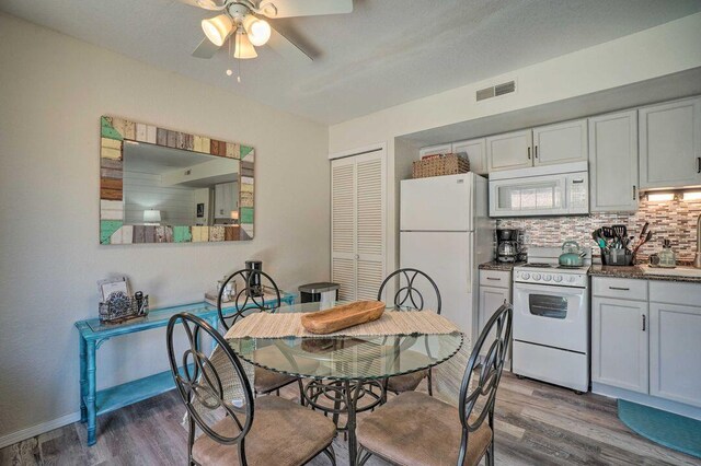 570 Abby Ln Unit 3, Branson, MO 65616 - kitchen with white appliances, wood finished floors, a ceiling fan, backsplash, and baseboards