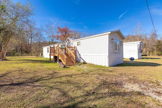 view of home's exterior featuring stairs, a wooden deck, and a yard