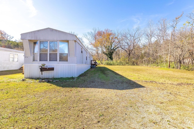 view of side of property with a lawn