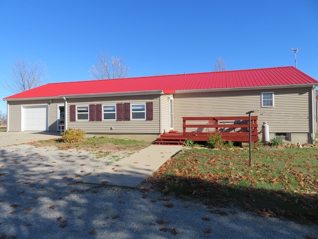 view of front of house featuring a garage and a wooden deck