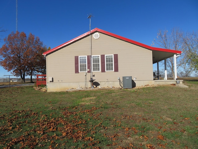 view of side of property with a lawn and central air condition unit