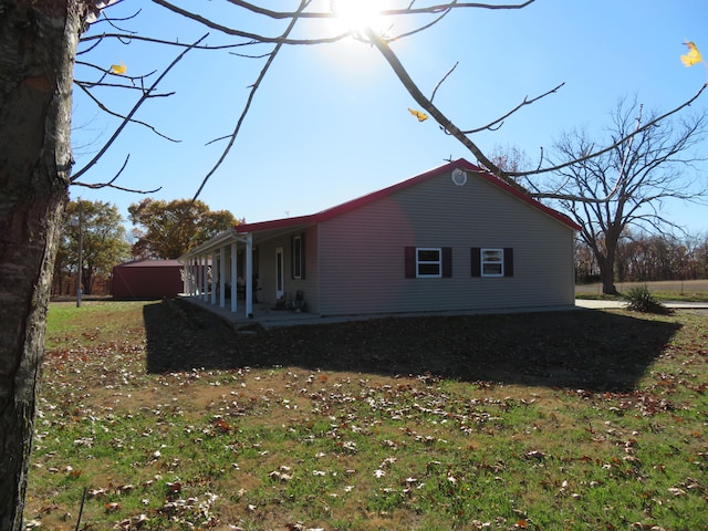 view of side of property with a yard