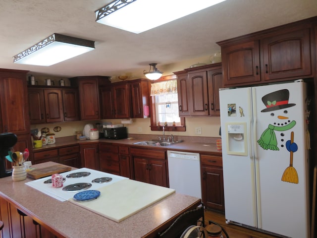 kitchen featuring sink and white appliances