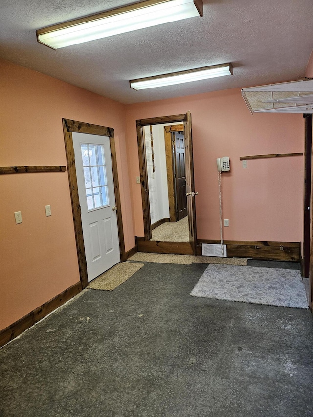 entryway featuring a textured ceiling